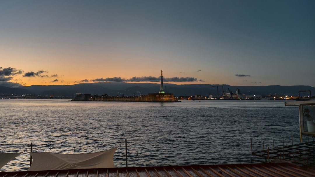 a body of water with a tower in the distance